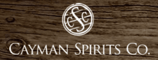 Cayman Spirits Co. logo on wood background.